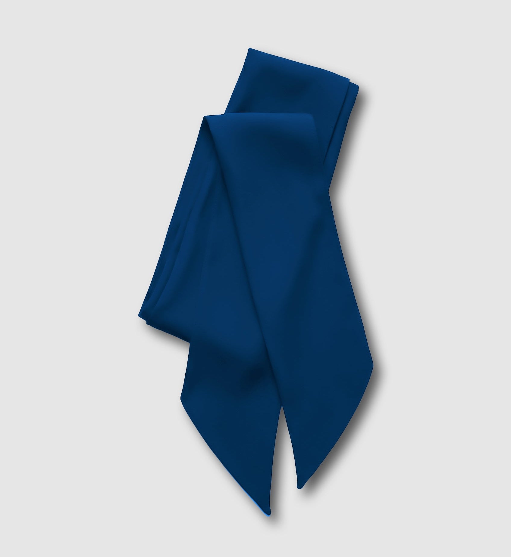 Blue silk scarf folded on a grey background