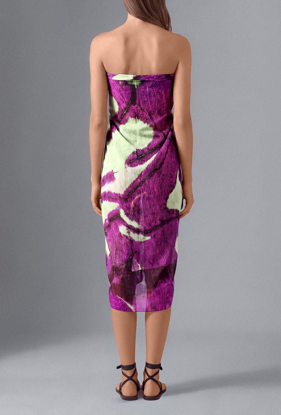 Back view of model wearing the Isabella Kron Butterflywing Pareo in purple, crafted in Italy from lightweight 100% cotton voile.