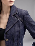 Close-up of the Isabella Kron Carnaby denim jacket with contrast stitching, brass-tone buttons and structured shoulders
