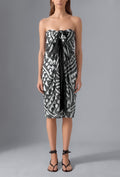 Model wearing the Isabella Kron Graffito Pareo in Black & White, crafted in Italy from lightweight cotton voile and styled as an elegant strapless resort cover-up.
