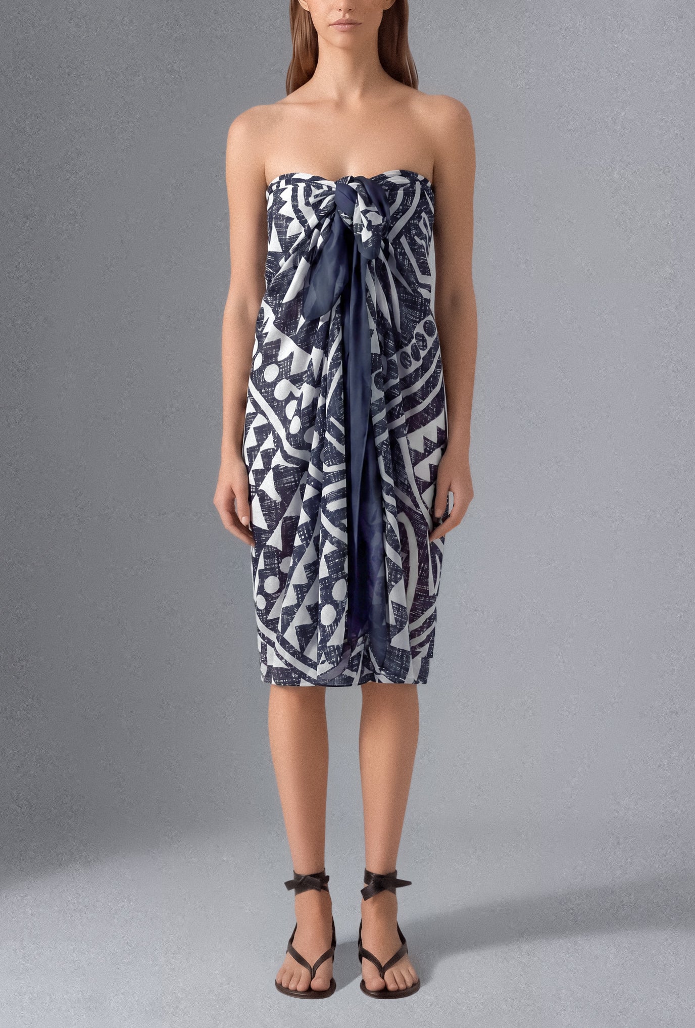 Model wearing the Isabella Kron Graffito Pareo in Blue & White, crafted in Italy from lightweight cotton voile and styled as an elegant strapless resort cover-up.
