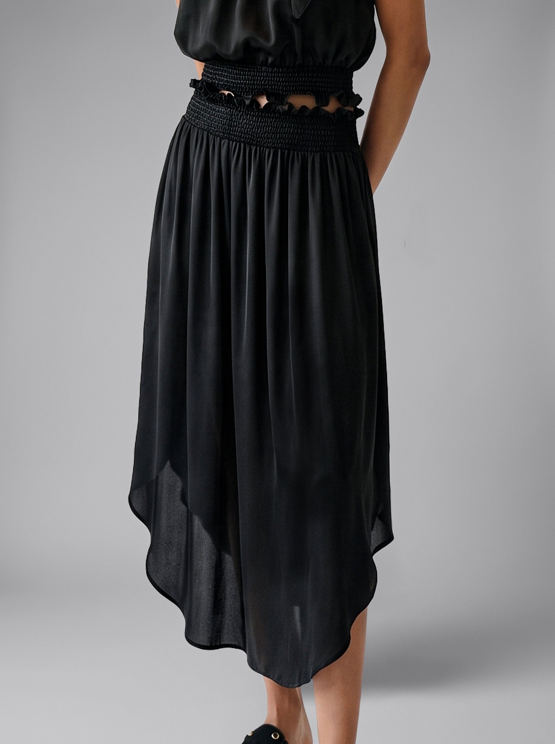 Close-up of the smocked waistband on the Lily black silk midi skirt