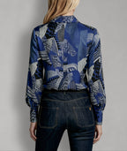 Back view of Isabella Kron Linda Shirt in black iris print, showcasing central back pleat and striking botanical design