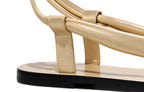 Close-up detail of gold metallic leather straps and knot detail on Patti Sandal