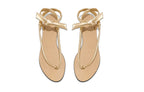 Gold leather wrap sandals with delicate ankle ties and minimalist flat silhouette photographed from above on a white background