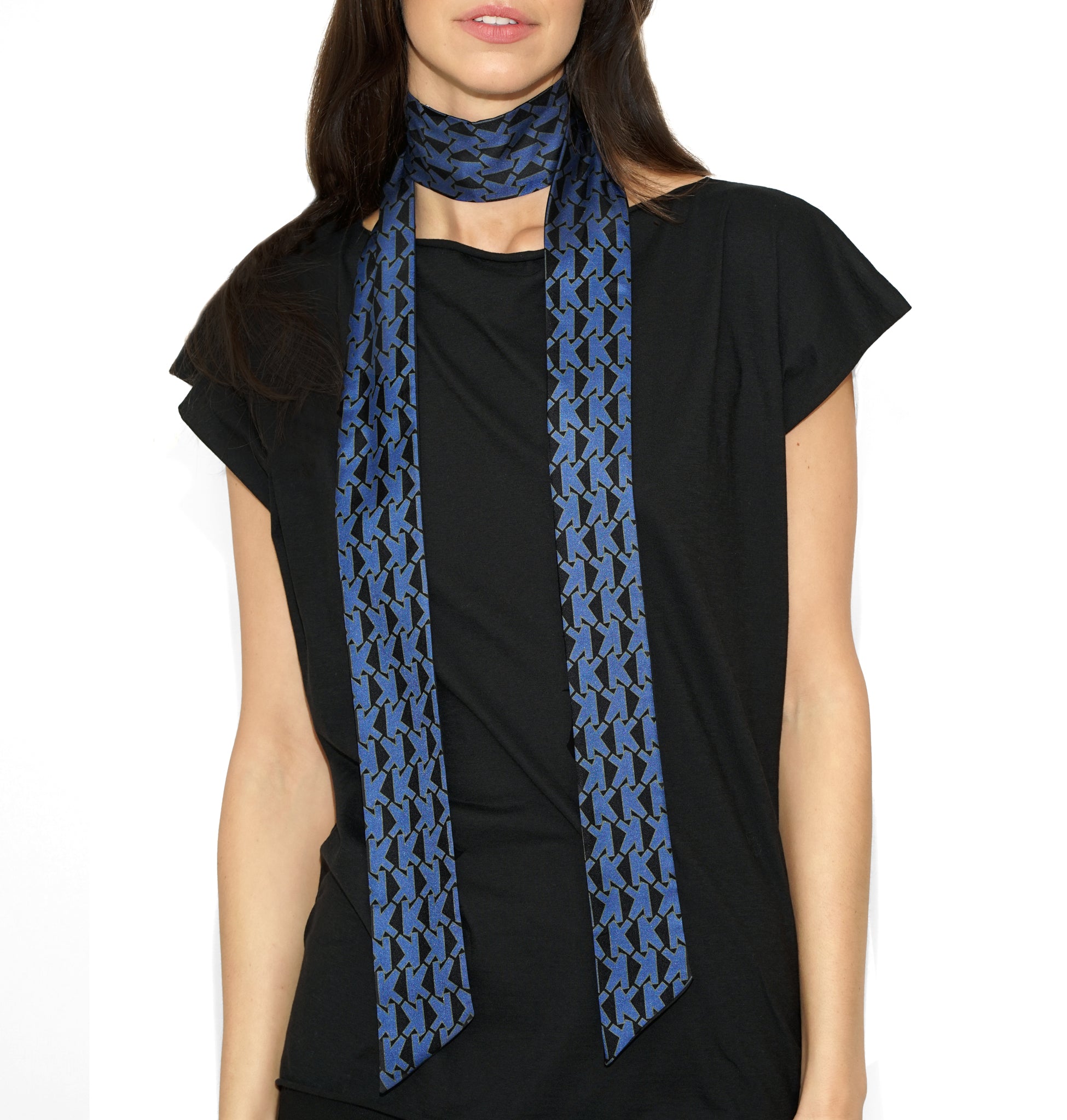 Front draped view of Isabella Kron Alice K Scarf in vivid blue, loosely wrapped around the neck showcasing its long rectangular silk shape and soft sheen