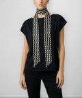 Front draped view of Isabella Kron Alice Scarf in black and white, loosely worn around the neck showcasing bold graphic pattern and smooth silk texture