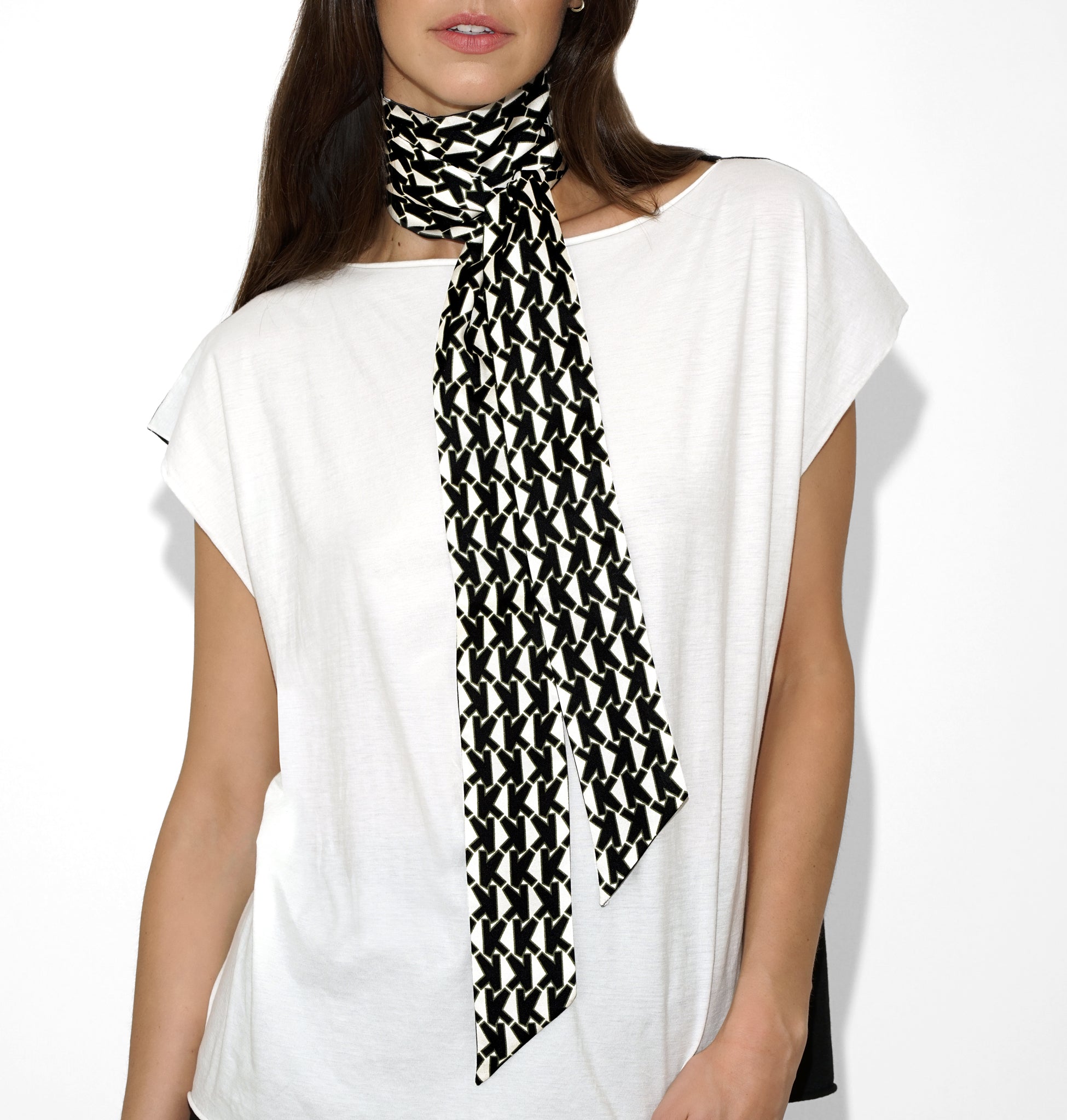 Styled view of Isabella Kron Alice Scarf in black and white tied in a chic front knot over a tailored white shirt, reflecting bold yet refined elegance