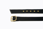 Side angle of brass buckle, matching eyelets, and black leather trim on Isabella Kron Blix Belt