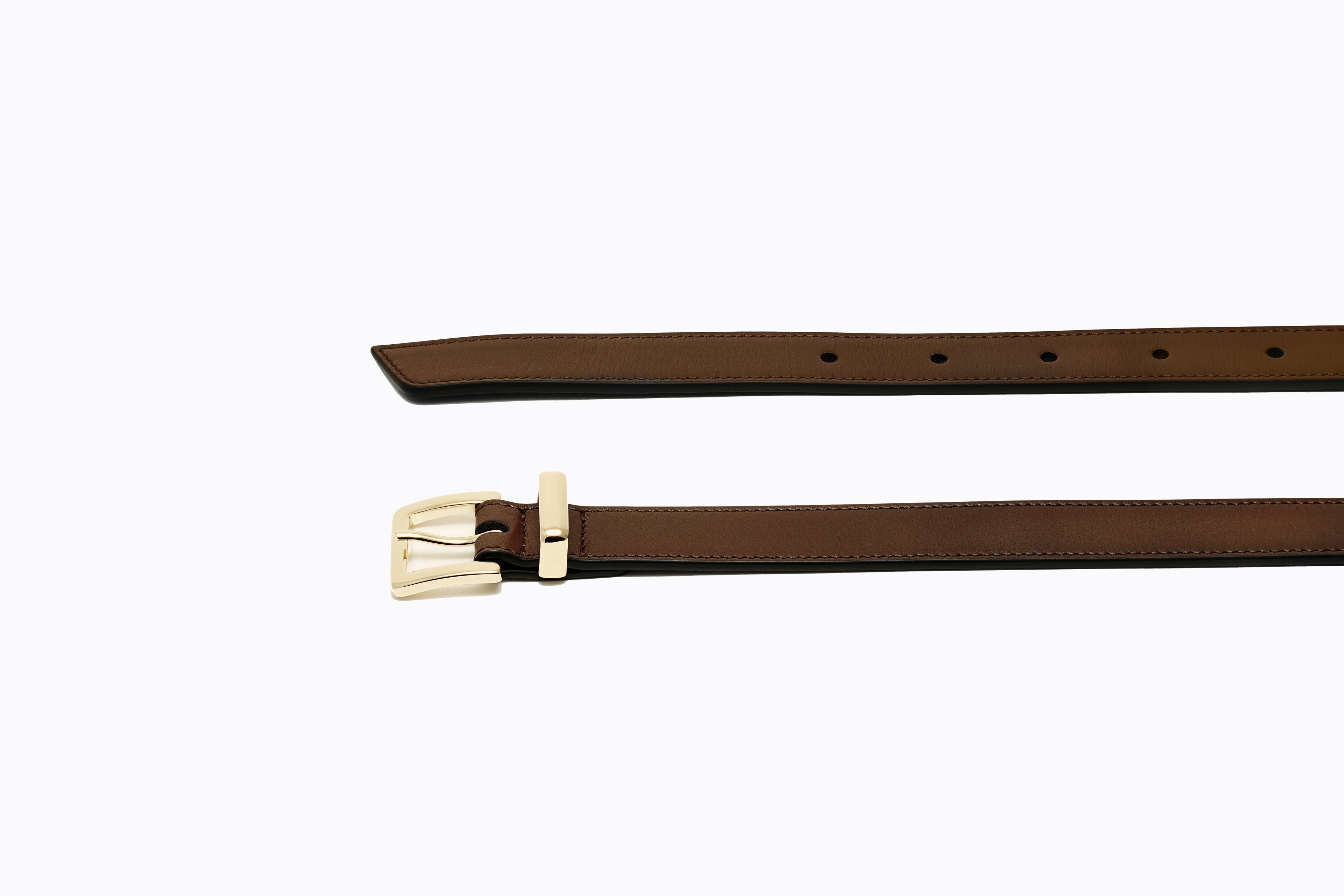 Close-up of polished gold buckle and fine-grain toffee leather on Isabella Kron Brylee Belt, showcasing craftsmanship