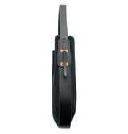Side view of Ibbie Bag in black canvas – structured silhouette with premium leather trim and gold accents