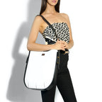 Model holding the Ibbie Bag in white leather – modern designer handbag perfect for day-to-night transitions
