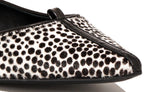 Angled view of Isabella Kron Julie Flat in Kasba raffia, showing toe, woven texture, and laid-back yet refined silhouette