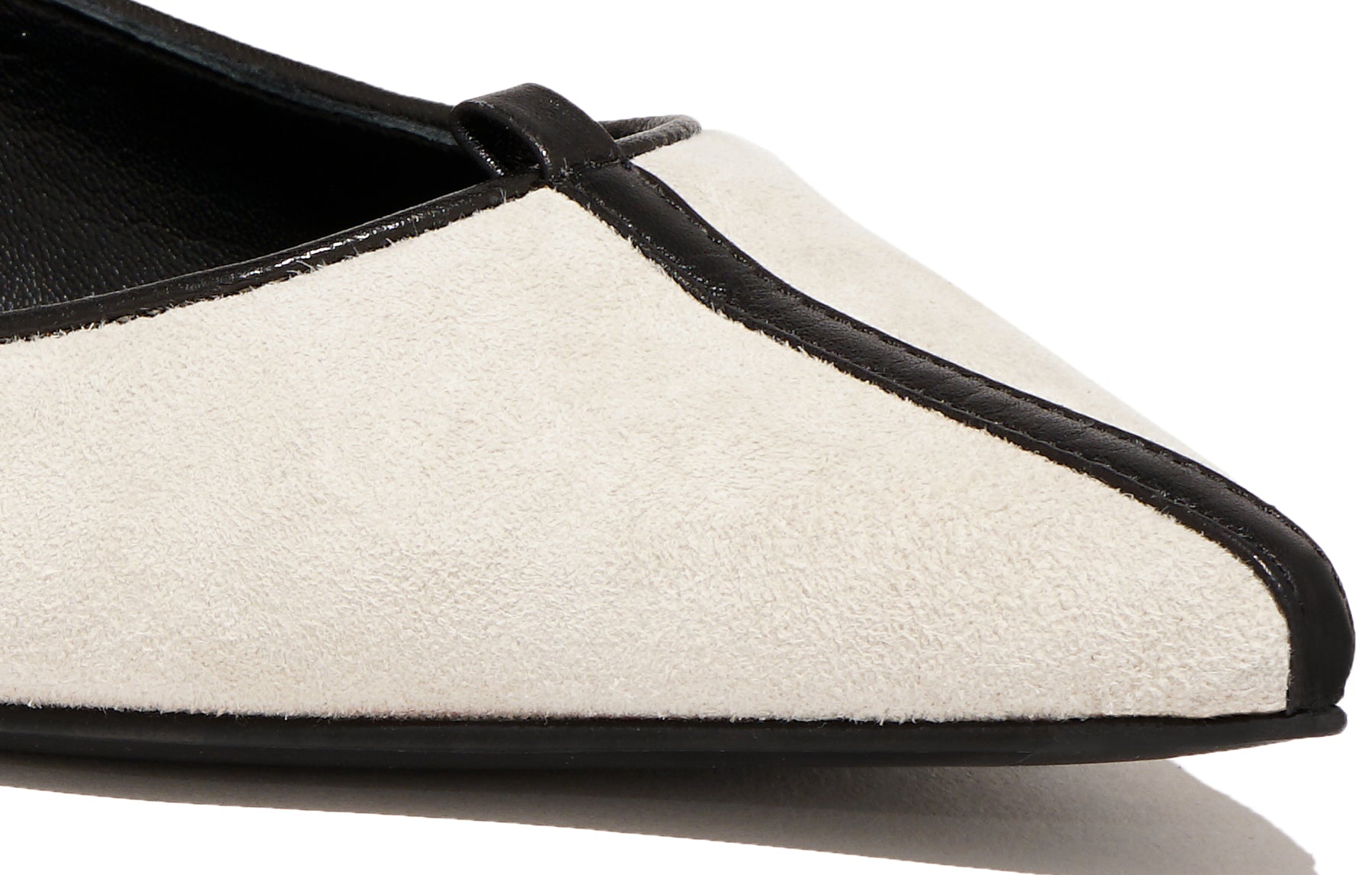 Angled view of Isabella Kron Julie Flat Albatros in off‑white suede, showing toe, sleek silhouette, and luxurious suede texture