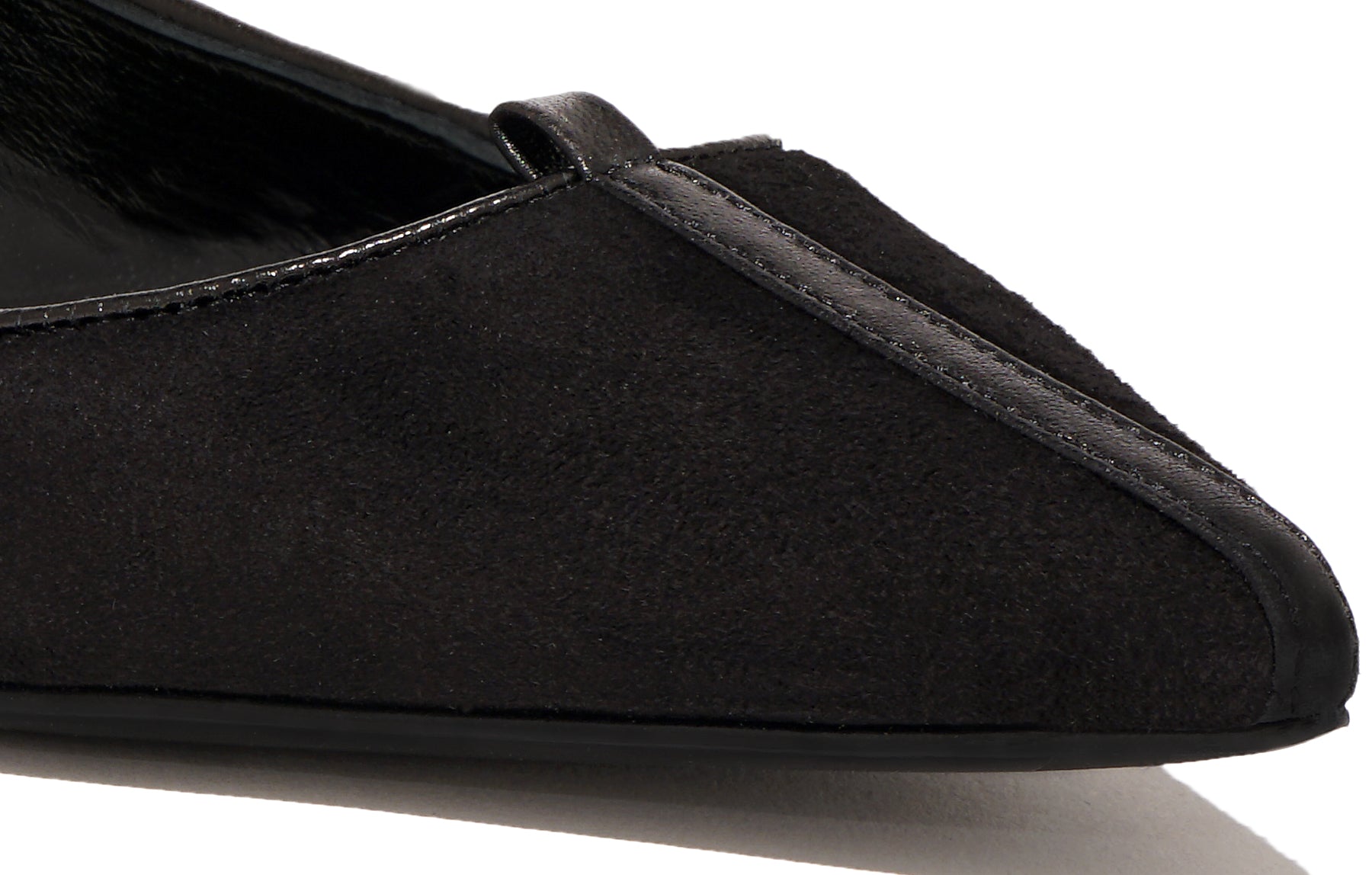 Angled view of Isabella Kron Julie Flat in Asiago Nero black suede, showing toe, elegant silhouette, and refined profile