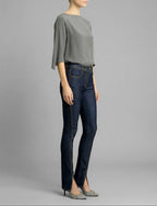 Side view of Isabella Kron K‑22 Jean in dark indigo worn by model, showcasing mid-rise waist and slender leg silhouette