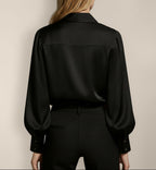 Back view of Isabella Kron Linda silk shirt in black, highlighting smooth silk panel and clean tuckless back