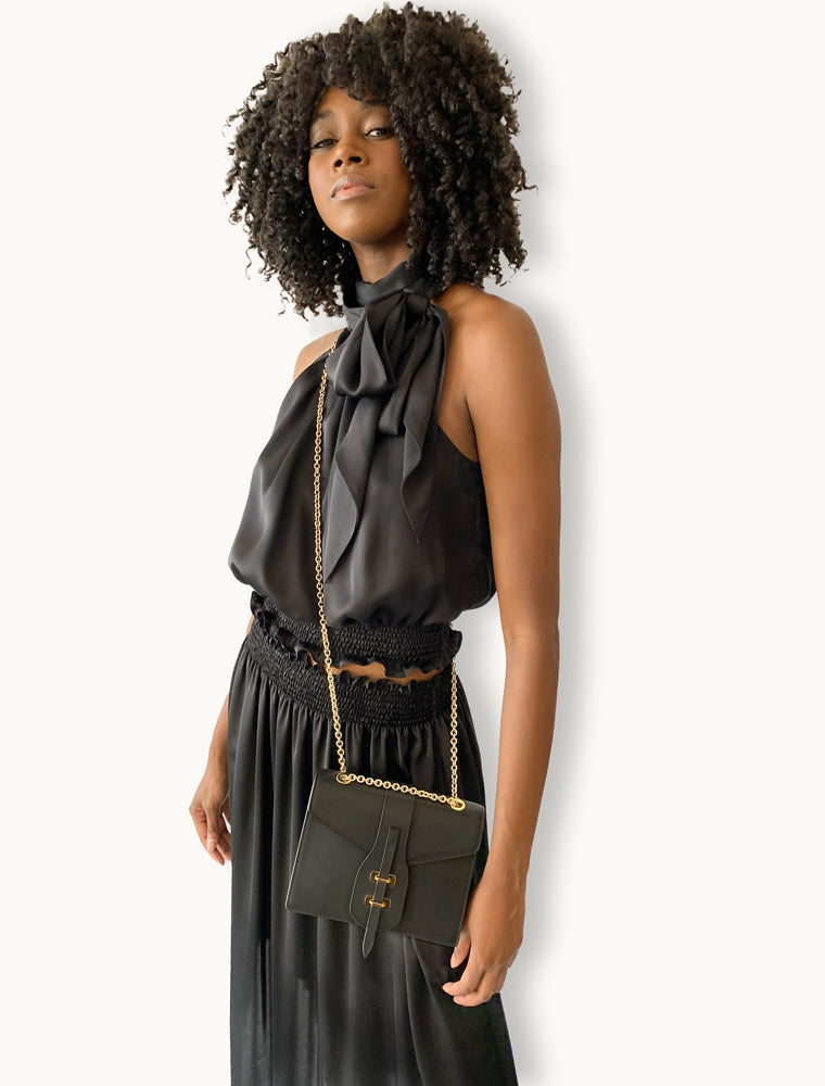 Model carrying Marcella Chain Bag in black – refined style with luxurious finish