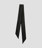 Close-up of Isabella Kron Nina silk scarf in black, showing fine silk weave, stitched edge, and subtle luster