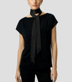 Front view of Isabella Kron Nina silk scarf in black, draped loosely around the neck showing smooth silk sheen and long rectangular shape