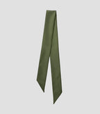 Close-up of Isabella Kron Nina silk scarf in military green, showing fine silk weave, stitched edge, and soft luster