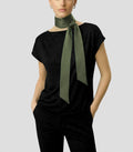Front view of Isabella Kron Nina silk scarf in military green, draped loosely around the neck showing smooth silk sheen and long rectangular shape