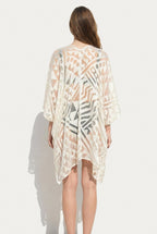 Back view of Isabella Kron Nomad Cover‑Up in ivory, showcasing straight back seam and relaxed fit over swimsuit or daywear