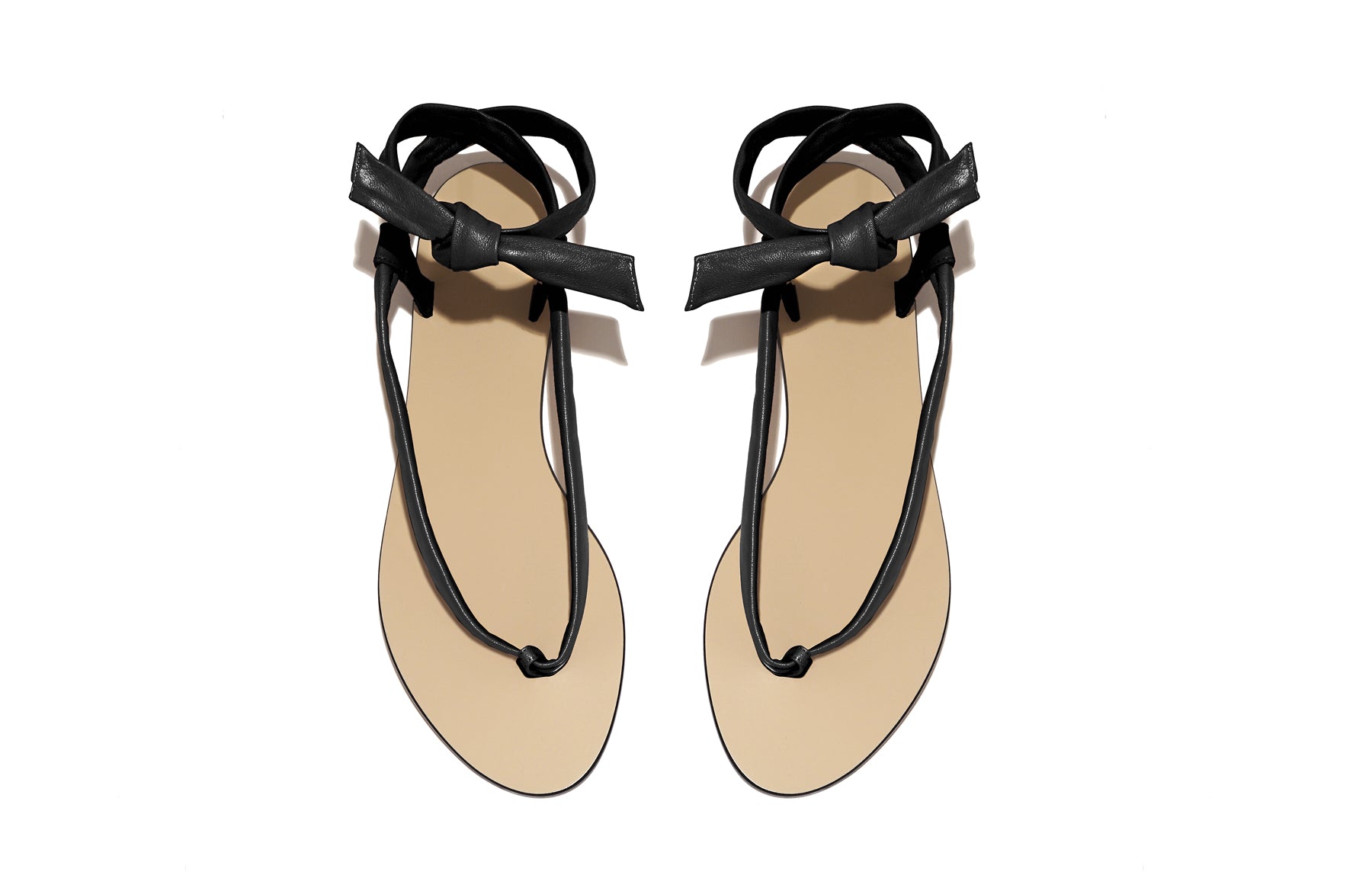 Side view of Patti Sandal in black – sleek and minimalist flat sandal in smooth Italian leather