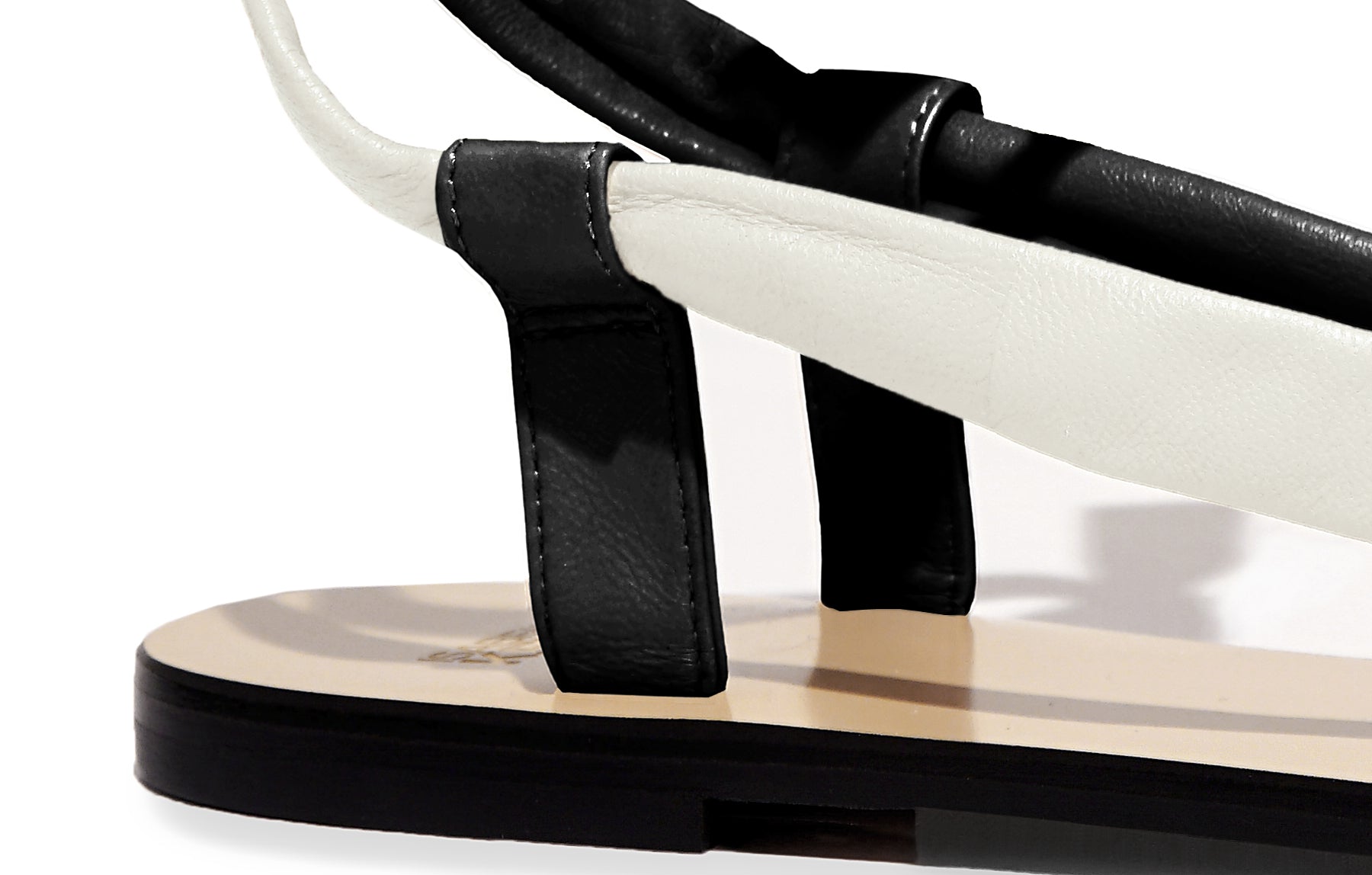 Detail of Patti Sandal in tapioca and nero – soft nappa leather, refined craftsmanship, and slim silhouette