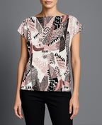 Model wearing Roxanne T-Shirt in Pink/Black – statement tee styled with minimalist flair