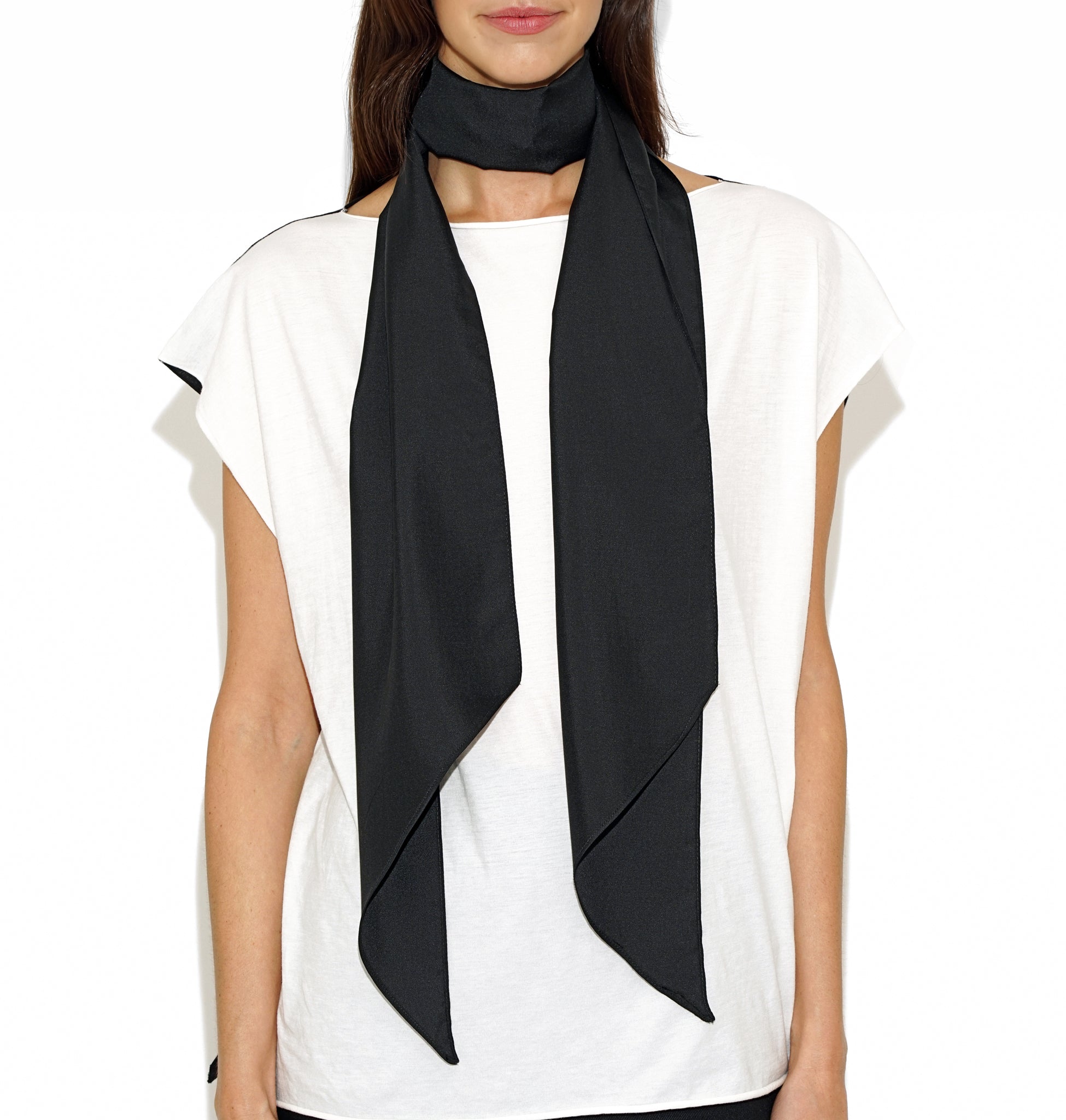 Front view of Isabella Kron Tyler silk scarf in black, draped around the neck showing smooth silk sheen and long rectangular shape