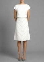 Model wearing the Isabella Kron Warwick white cotton drill skirt with chevron topstitching